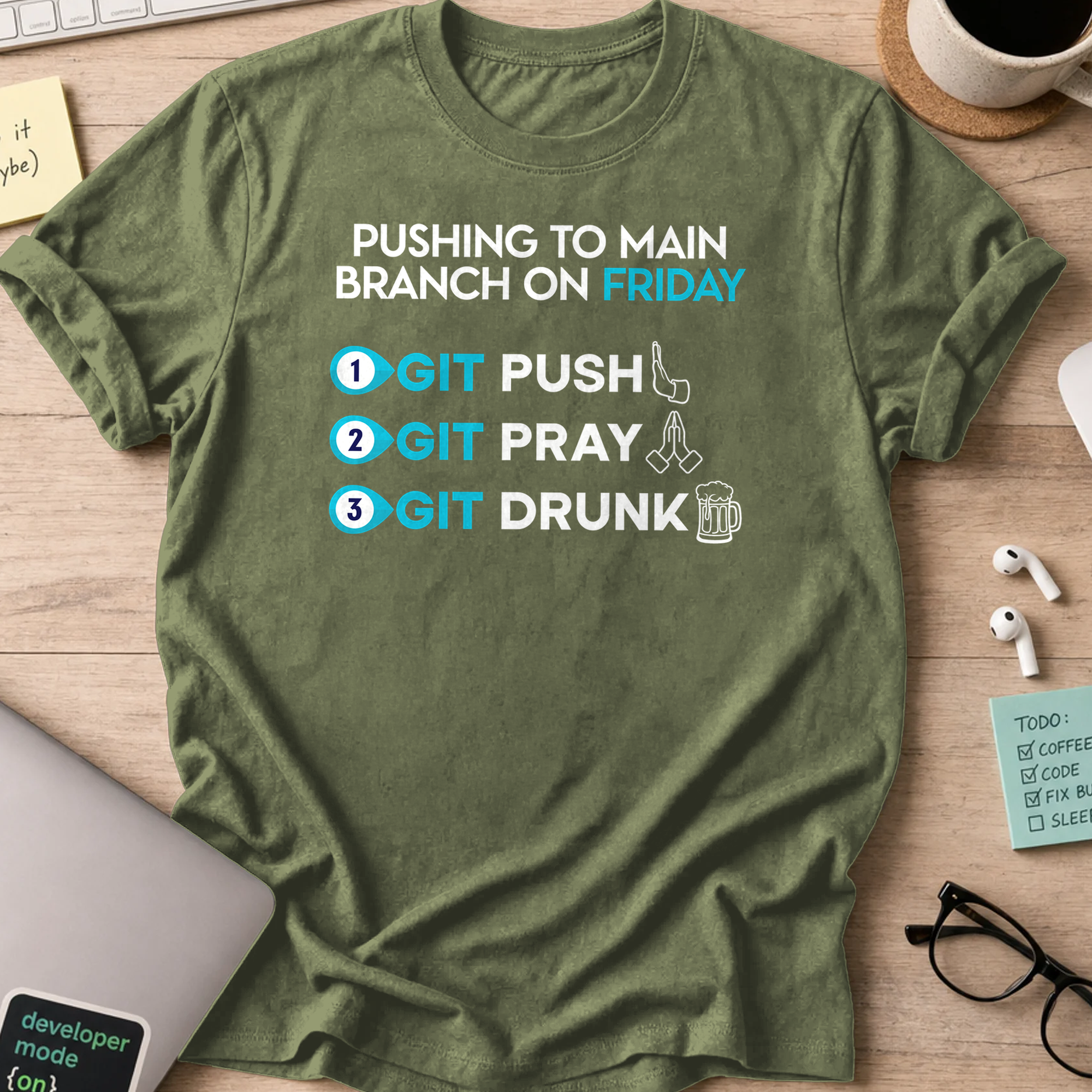 Military Green programmer shirt printed with "pushing to main branch on friday", a funny developer t-shirt and coding gift for software engineers.