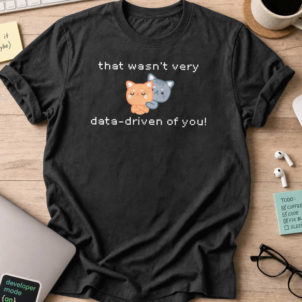 Black programmer shirt printed with "that wasn't data driven of you cats" and a cat graphic, a funny developer t-shirt and gift for developers.