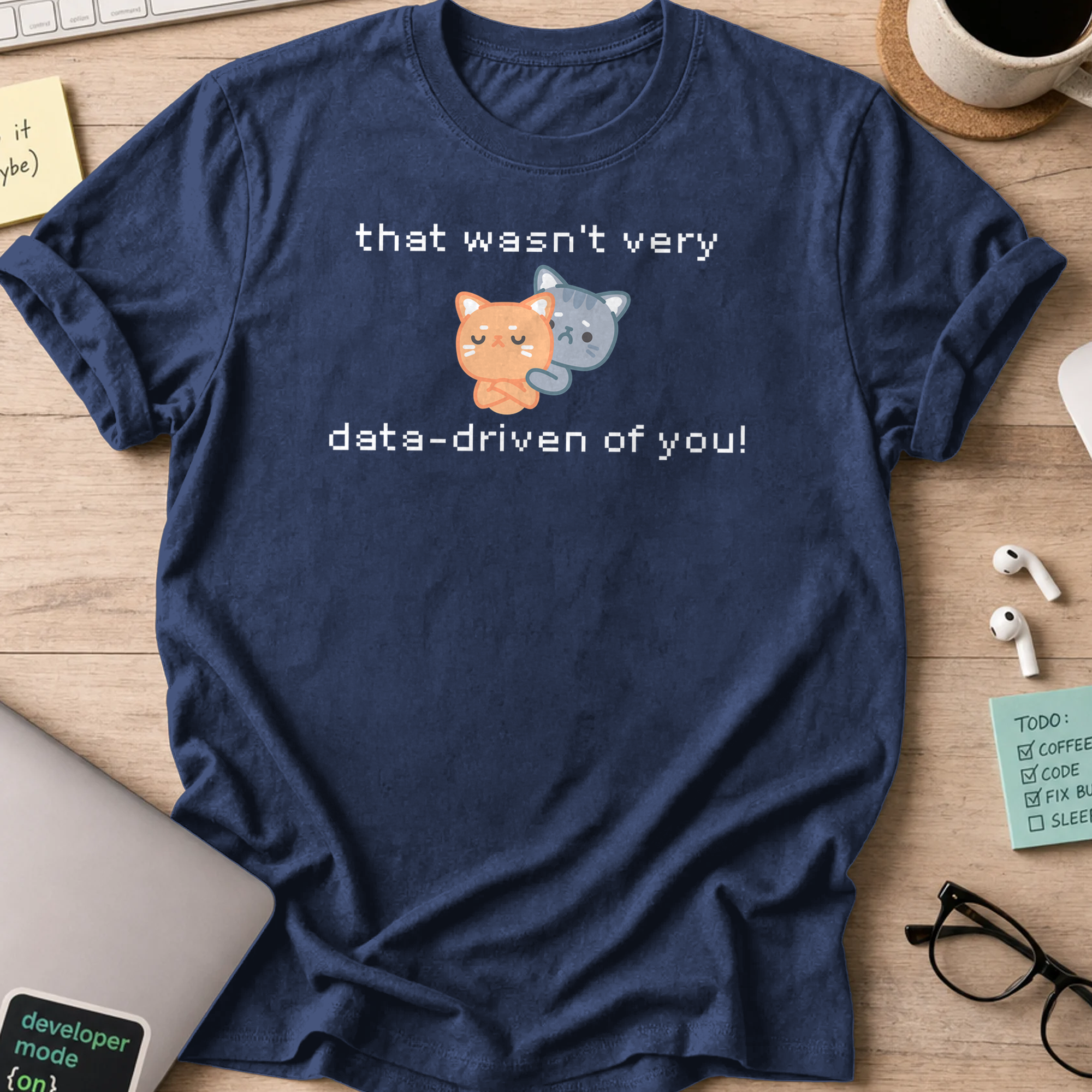 Navy programmer shirt printed with "that wasn't data driven of you cats" and a cat graphic, a funny developer t-shirt and gift for developers.