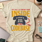 The Call Is Coming from Inside the Codebase Shirt — Natural storefront mockup