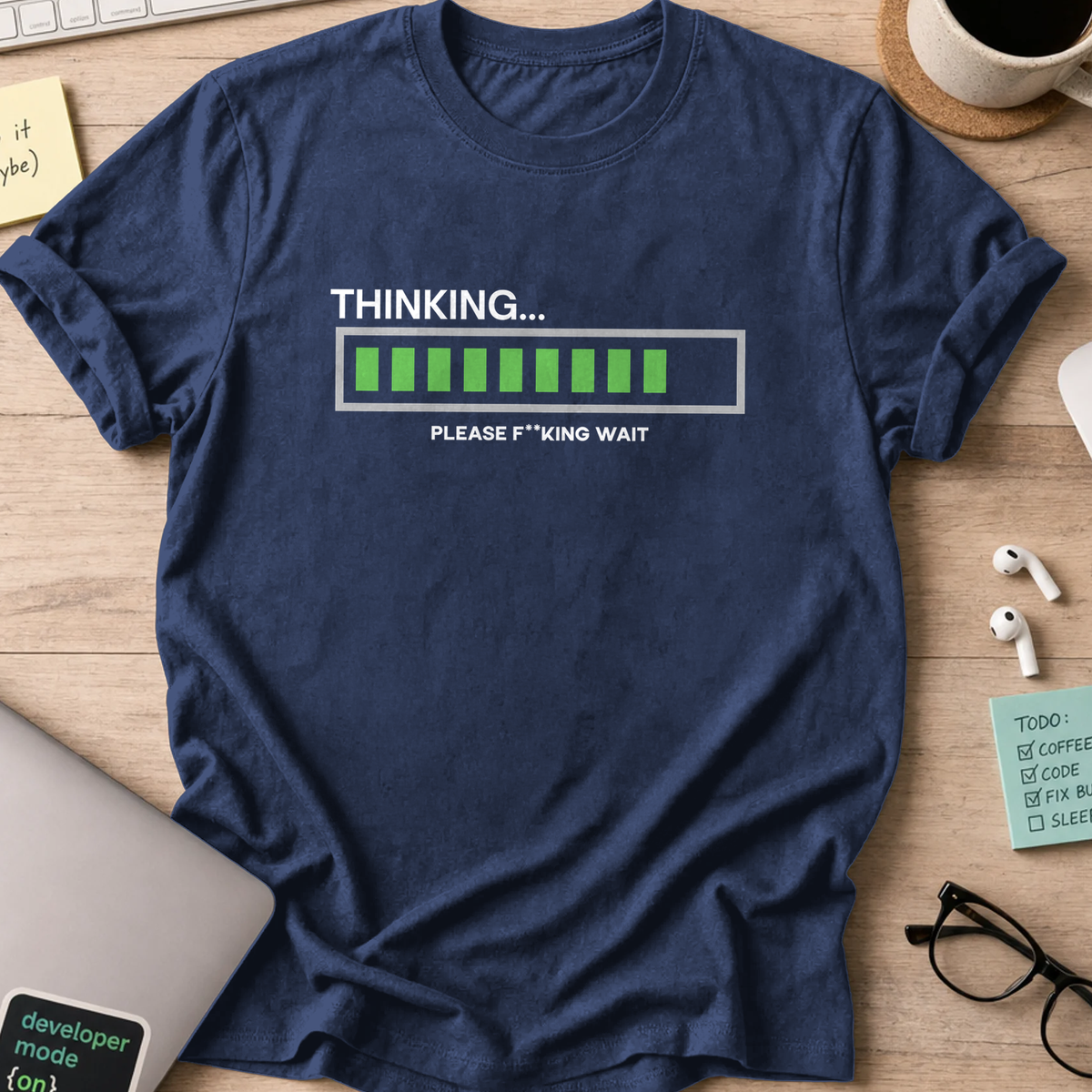 Navy programmer shirt printed with "Thinking... Please wait", a funny developer t-shirt and coding gift for software engineers and coders.